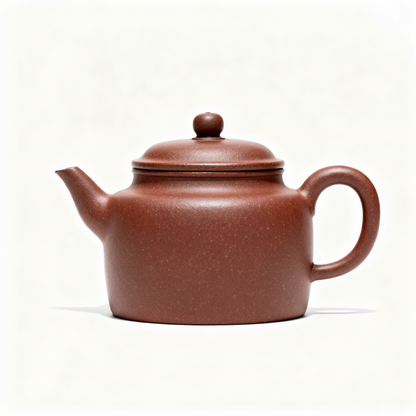 Warm reddish-brown covered teapot with curved handle and short spout on a clean white background